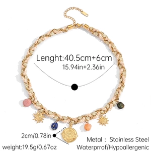 Detail of bohemian sun pendants and stones on a pink braided stainless steel necklace