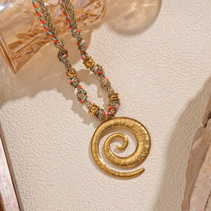Bohemian gold spiral pendant necklace with colorful woven rope and retro metal accents