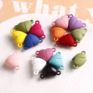Colorful matte heart magnetic clasps for DIY jewelry making on a white plate
