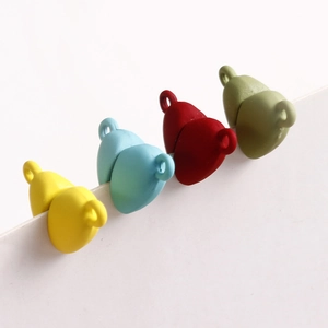 Close-up of matte heart-shaped charms in four colors for DIY jewelry making and crafts