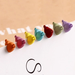 Detail of colorful matte heart-shaped charms with metal loops for DIY jewelry making