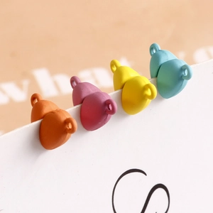 Close-up of colorful matte heart pendants with dual rings for DIY bracelet making