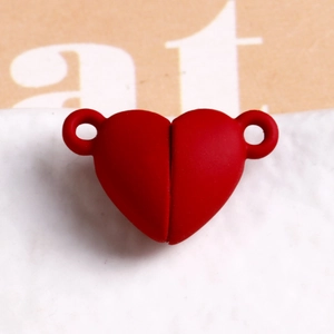 Macro view of a matte red heart-shaped magnetic clasp for DIY jewelry connecting