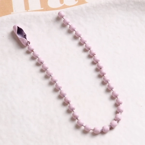 Macro shot of light purple painted metal ball chain with matching connector clasp
