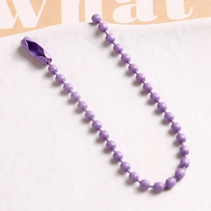 Macro view of purple matte finish iron bead chain with matching connector clasp for DIY crafts