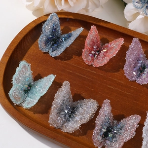 Detail view of handmade butterfly fabric patches with sparkling sequins for DIY jewelry