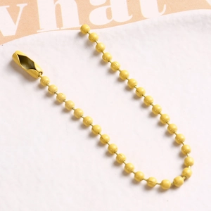 Detail of a bright yellow lacquered ball chain with a secure connector clasp