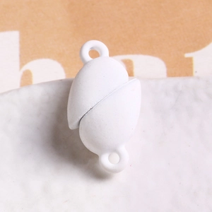 Macro view of white matte oval magnetic clasp with dual attachment loops for DIY bracelets