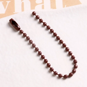 Macro view of dark brown ball chain with connector clasp for DIY jewelry and tags