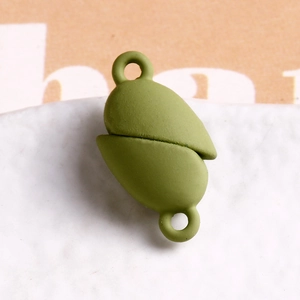 Macro shot of grass green matte magnetic jewelry clasp with loops for DIY bracelets