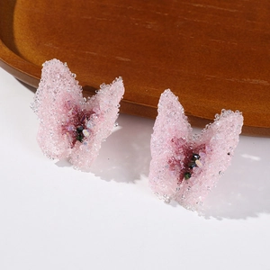 Macro view of pink fabric butterfly accessories with sparkling beads and crystals
