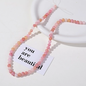 Detail of 8mm pink and orange crackle quartz beads for DIY jewelry making