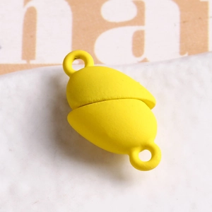 Close-up of yellow matte peanut-shaped magnetic clasp for DIY jewelry making