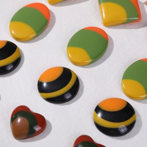 Flatback resin jewelry charms featuring colorful striped geometric shapes for DIY crafts