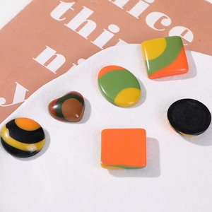 Macro shot of assorted resin cabochons with retro striped texture for DIY jewelry making