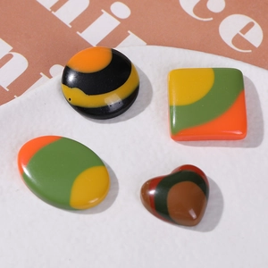 DIY resin accessories set with geometric shapes and colorful marble patterns in a white tray