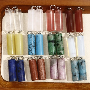 Macro view of assorted cylindrical natural stone pendants for DIY jewelry making