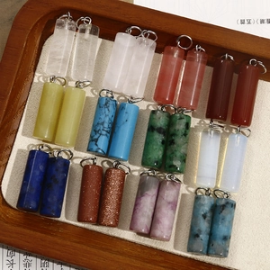 Macro shot of assorted natural stone cylinder pendants with silver bail for jewelry DIY