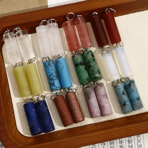 Detailed macro view of assorted cylindrical natural stone charms with silver metal rings