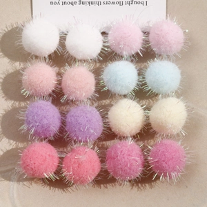 Detailed view of 16 sparkling colorful plush pom-poms for DIY earring and hair accessories