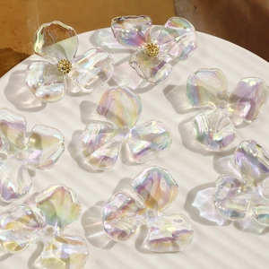 Macro shot of iridescent acrylic flower charms for jewelry making with aurora finish