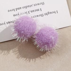 Detail of lavender plush pom poms with silver tinsel for DIY jewelry and hair accessories
