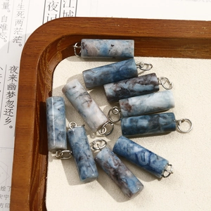 Macro view of natural ink-pattern stone cylinder pendants for DIY jewelry making