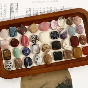 Macro view of polished assorted natural stones like agate and tiger eye in geometric shapes