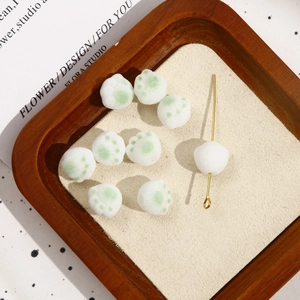 Close-up of cute flocked cat paw beads for DIY jewelry with soft plush texture