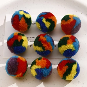 Macro shot of colorful 30mm fuzzy pom-pom balls for DIY jewelry and hair accessories
