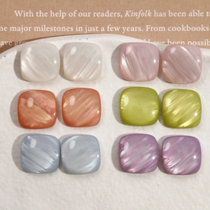 Macro detail of square pearlescent resin charms in six vibrant candy colors for DIY jewelry
