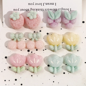 Detailed view of colorful flocked fruit and floral resin charms for DIY hair accessories