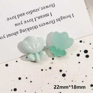 Detail view of mint green tulip charms in resin and flocking material with 22mm x 18mm size