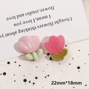 Detail of 22mm tulip resin charms with pink flocking and translucent textures for DIY crafts