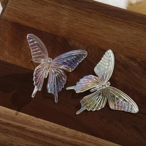 Macro detail of iridescent butterfly charms with exquisite textures and metal pins