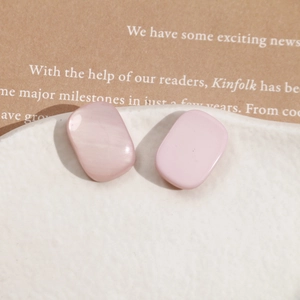 Detail of pink rectangular resin jewelry charms with a smooth pearl-like finish