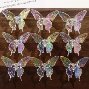 Macro view of nine iridescent resin butterfly ornaments on a vintage dark wood background