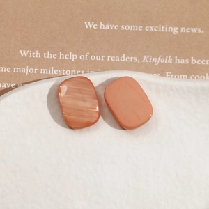 Macro view of rectangular terracotta resin studs with marble texture on ceramic plate