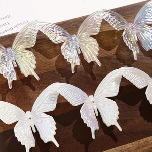 Detailed view of iridescent butterfly resin charms for DIY hair accessories and phone cases