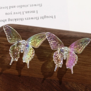 Macro shot of iridescent acrylic swallowtail butterfly charms with holographic finish