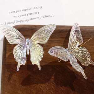 Detailed view of iridescent AB color acrylic swallowtail butterfly accessories on wood