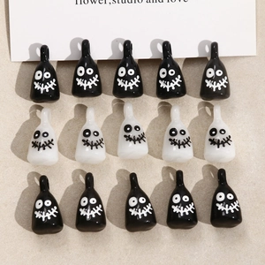 Macro view of 15-piece black and white cartoon ghost resin charms for DIY jewelry making