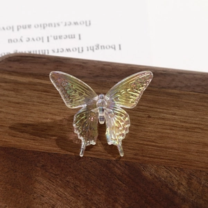 Detail of translucent acrylic swallowtail butterfly bead with aurora iridescent finish