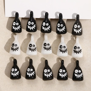 Detail of DIY Halloween ghost pendants with glossy resin finish and funny faces