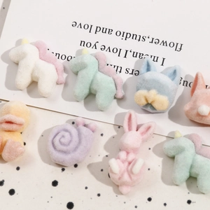 Macro detail of assorted flocking cartoon animal charms in soft macaron colors