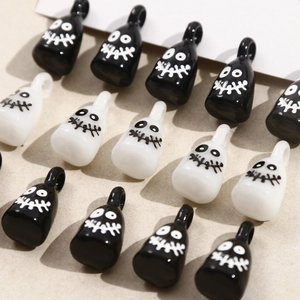 Macro view of cartoon ghost resin pendants in black and white for DIY jewelry making