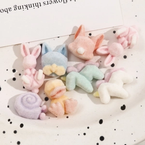 Macro shot of colorful flocked animal charms in soft macaron colors for DIY crafts