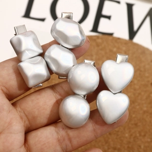 Polished silver-tone heart and geometric hair clips with a pearl-like metallic finish