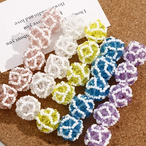 Close-up of handmade woven crystal bead balls in assorted colors for DIY jewelry crafting