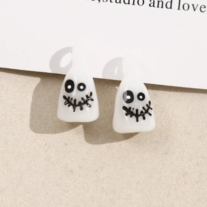 Detailed macro view of white resin ghost pendants with quirky faces for DIY jewelry making